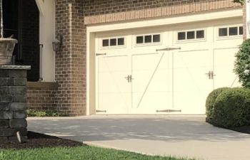 Residential double garage with carriage doors.