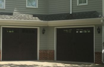 Residential building with updated garage doors.