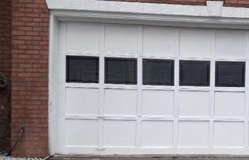 A red-brick house with new double garage door.
