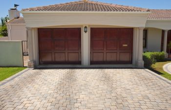 Wooden brown double garage doors of a big residential house.