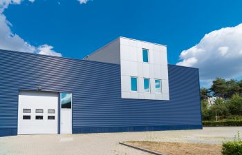 Modern warehouse building with garage door.