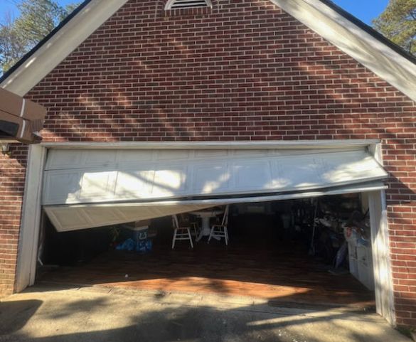 Car knocked garage door off-track